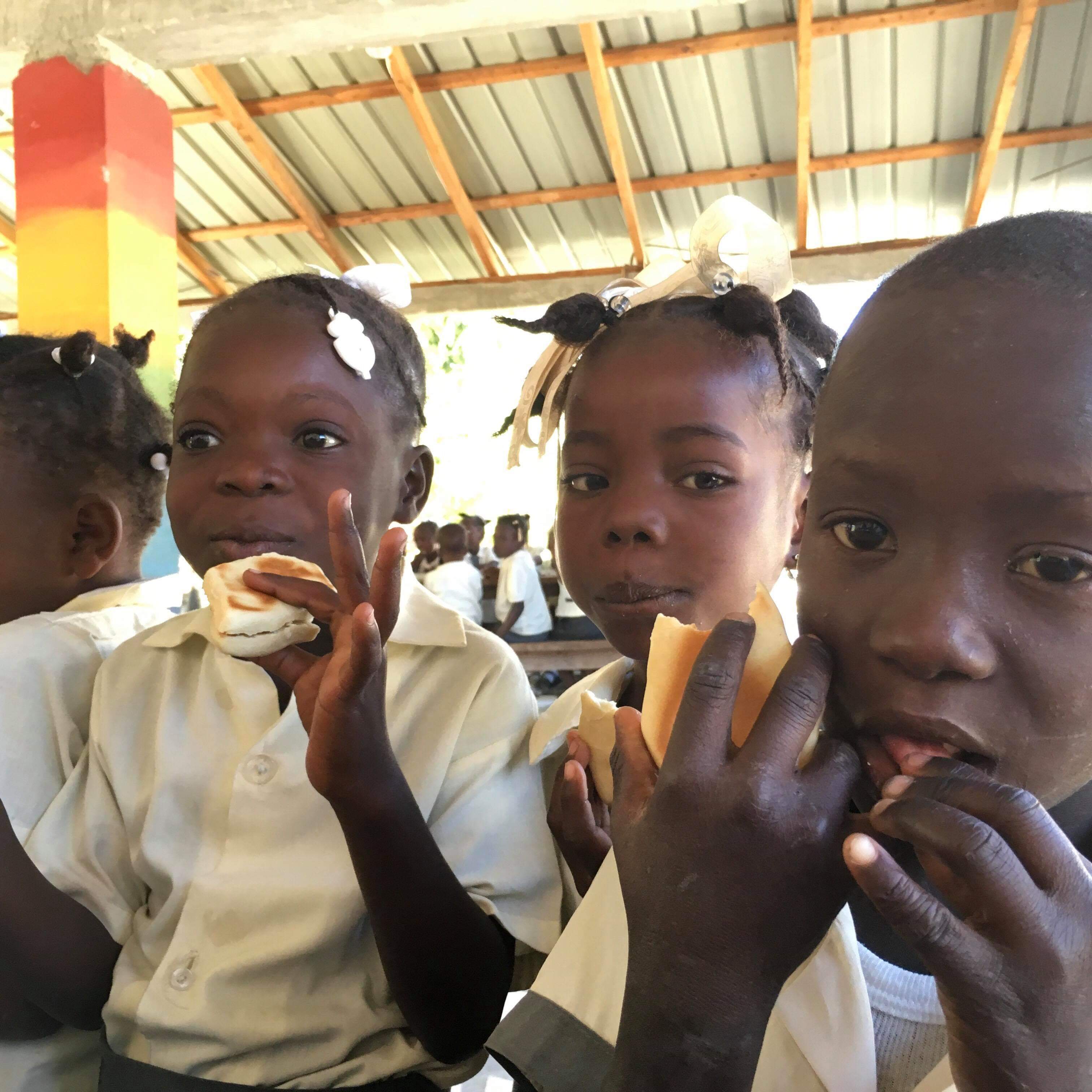 Photo of three children eating